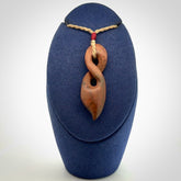 A wonderful twist pendant carved in jade that has been heated