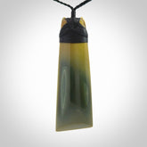 A large and beautiful hand carved toki pendant. This piece is carved from New Zealand flower jade by NZ Pacific. This is a wonderful large toki bound with a black cord and a traditional black lashing.