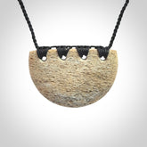 Hand carved whale bone breastplate pendant.