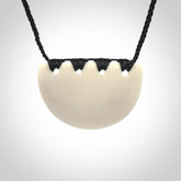 Hand carved bone breastplate pendant.