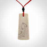 Hand carved bone toki pendant