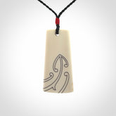 Hand carved bone toki pendant