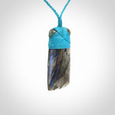 This picture shows a Labradorite stone toki pendant that we have hand carved.