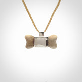 This is a hand carved deer antler dog bone dog tag. It is made from deer antler, bone and sterling silver. Hand made dog tags for your dog.