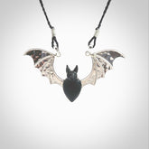 This is a hand carved bat pendant. It is made from Black Jade and Sterling Silver. This is a medium sized necklace and is a very unique, one only, pendant that is a collectors piece. Provided with black adjustable cord.