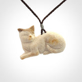 This cat pendant radiates quiet elegance with a regal composure. Hand made in bone.