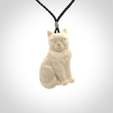 A charismatic cat pendant, hand carved in bone