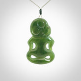 This pendant is a large jade tiki pendant. The carving shows wonderful detail on the front while the back is beautifully rounded. These are carved in Columbian Jade. The cord is adjustable in length. Provided in a woven kete pouch and shipped worldwide.