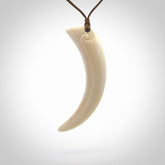 Hand carved incredible Huia bird beak bone carving. A stunning work of art, beautifully replicating a hula bird beak. This pendant was hand carved in bone by artist Yuri Terenyi. A one off pendant that has been hand crafted to be worn.