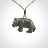 This picture shows a pendant that we designed in New Zealand jade. It is a little green bear that has a walking stance and is carved in detail. A really attractive and eye-catching piece of handmade jewellery. The cord is hand plaited braid and the length can be adjusted.