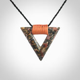 This is a hand carved triangle pendant made from a gorgeous and striking piece of Tiger Jasper. This is a hand carved and very unique necklace. For sale online from NZ Pacific. Delivered with adjustable cord.