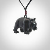 This picture shows a pendant that we designed in black jade. It is a little black bear that has a walking stance and is carved in detail. A really attractive and eye-catching piece of handmade jewellery. The cord is black and the length can be adjusted.