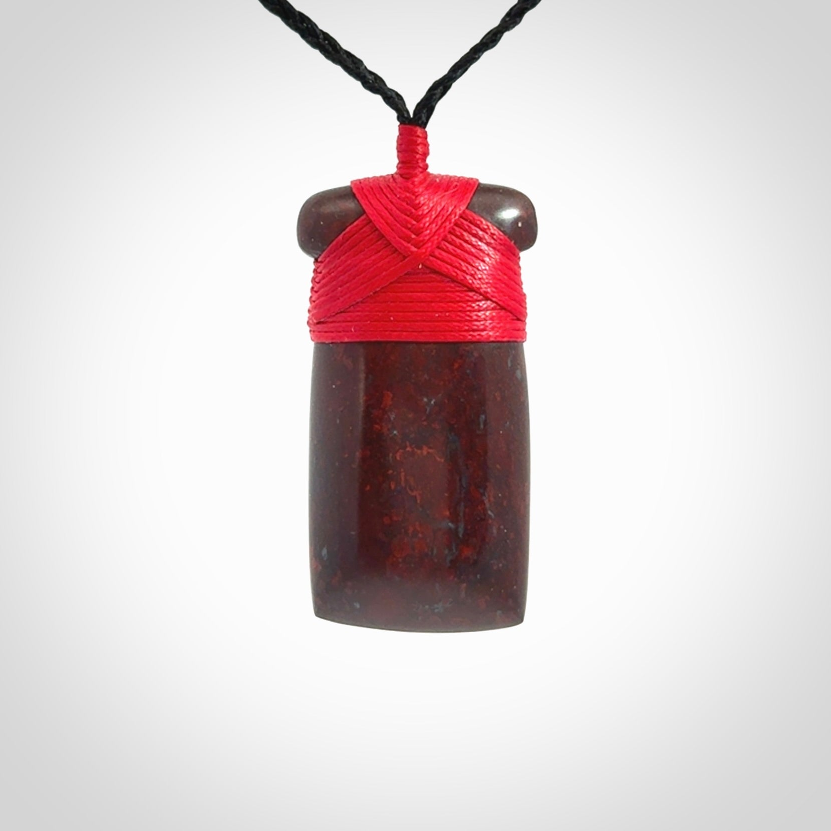 This is a beautiful hand carved Red Jasper Stone toki pendant. A really cool piece that is made from this rare and beautiful material. The red jasper has a very distinctive look and each piece is different. We ship this worldwide and the cost of shipping is included in the price. Provided with adjustable cords and packaged in a woven kete pouch.