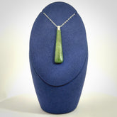 A hand carved New Zealand Jade Drop pendant with sterling silver clasp and chain.