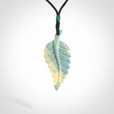 Hand carved blue Mammoth Tusk feather pendant with adjustable cord. Woolly Mammoth tusk feather necklace. Hand carved by NZ Pacific. Art to Wear.