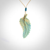 Hand carved blue Mammoth Tusk feather pendant with adjustable cord. Woolly Mammoth tusk feather necklace. Hand carved by NZ Pacific. Art to Wear.