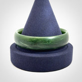 Hand carved New Zealand Jade bangle with matte finish, by Ric Moor. This is a spectacular one off, bracelet hand made in New Zealand from gorgeous Jade. Unique art to wear, delivered in a woven kete pouch. Real New Zealand Jade. Outstanding craftsmanship by New Zealand Master Carver Ric Moor.