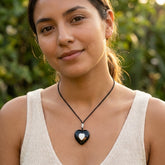 Woman wearing black jade heart pendant