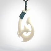 Hand carved bone hook with dolphin. This is a marine-themed pendant which we have made for dolphin lovers and for those of us that love the sea. This piece is handcarved from natural bone  and is shipped worldwide free.