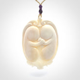 This is a contemporary large pendant carved in bone. Hand carved and provided with an adjustable cord. Twins in womb pendant.