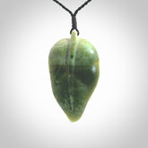 Hand carved New Zealand Jade leaf pendant with adjustable cord. This piece is a stand out work of creativity and skill and we love Raegan Bregmen's creations. Unique, one only, New Zealand made necklace for sale. Free shipping worldwide.