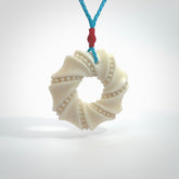A hand carved masterpiece. A beautiful contemporary pendant carved from bone by Yuri Terenyi for NZ Pacific. This is a true piece of wearable art which is collectible. A one-off masterpiece and quite unique. Provided with an adjustable paradise blue cord and packaged in a woven kete pouch.