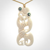 Hand carved bone Tiki pendant. Traditional art hand carved for NZ Pacific. Bone Tiki necklace with Paua Shell eyes. Delivered with Express Courier. Provided with adjustable cords and packaged in a woven kete pouch.