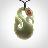 This picture shows a traditional manaia with hook pendant carved in New Zealand Jade.