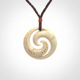 Hand carved koru pendant hand made in Woolly Mammoth tusk.
