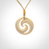 Hand carved koru pendant hand made in Woolly Mammoth tusk.