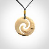 Hand carved koru pendant hand made in Woolly Mammoth tusk.