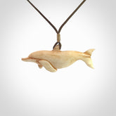 Hand carved dolphin bone pendant. Hand made bone dolphin necklace. Hand crafted bone dolphin pendant. Provided with an adjustable cord.