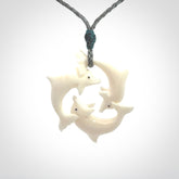 Hand carved dolphin trio pendant, made from natural bone by NZ Pacific. Hand made natural bone dolphin trilogy necklace, provided with an adjustable cord