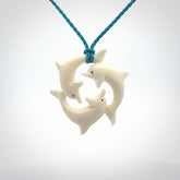 Hand carved dolphin trio pendant, made from natural bone by NZ Pacific. Hand made natural bone dolphin trilogy necklace, provided with an adjustable cord