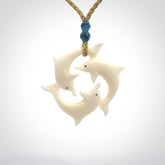 Hand carved dolphin trio pendant, made from natural bone by NZ Pacific. Hand made natural bone dolphin trilogy necklace, provided with an adjustable cord