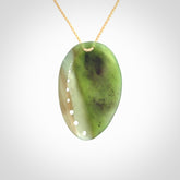 This is a unique pāua pendant, hand carved from New Zealand Jade. The cord is a creme colour and is length adjustable. This is delivered to you with Express Courier.