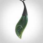 This is a unique drop pendant with koru, hand carved from New Zealand Jade. The cord is a black colour and is length adjustable. This is delivered to you with Express Courier.