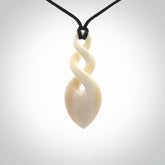 Hand carved bone double twist pendant. Beautiful hand made double twist bone necklace. Provided with an adjustable cord and packaged in a woven kete pouch. Free shipping worldwide.