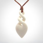 Hand carved bone double twist pendant. Beautiful hand made double twist bone necklace. Provided with an adjustable cord and packaged in a woven kete pouch. Free shipping worldwide.