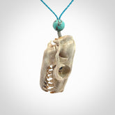 This is a hand carved deer antler cat skull pendant. It is made from deer antler, bone. This is a large sized necklace and is a very unique, one only, pendant that is a collectors piece. Hand carved deer antler cat skull necklace for men and women.