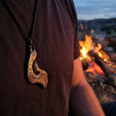 Man wearing bronze hook pendant