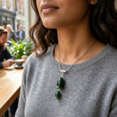 Woman wearing jade and silver flower necklace