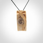 A hand carved bamboo with snail pendant carved from a piece of deer antler. This is a work of art carved by Fumio Noguchi who is renowned for his skill in bone carving. This is a great piece representing this very cool plant and animal.