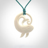 A hand carved bone whale pendant. This is a lovely piece carved to bring pleasure to the lucky wearer. It is a friendly pendant which we will ship to you free wherever you live. Carved by NZ Pacific and for sale online. Provided with an adjustable blue cord.