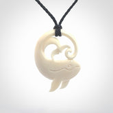 A hand carved bone whale pendant. This is a lovely piece carved to bring pleasure to the lucky wearer. It is a friendly pendant which we will ship to you free wherever you live. Carved by NZ Pacific and for sale online. Provided with an adjustable dark blue cord.