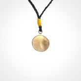 Hand made woolly mammoth tusk moon face necklace. Made by NZ Pacific and sale online only. Delivered with adjustable cord and packaged in a woven kete pouch.
