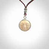 Hand made woolly mammoth tusk moon face necklace. Made by NZ Pacific and sale online only. Delivered with adjustable cord and packaged in a woven kete pouch.