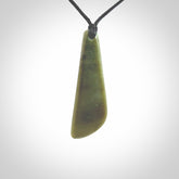 Hand carved small New Zealand Jade drop pendant. This pendant has been carved from New Zealand jade by NZ Pacific. We sell this piece with an adjustable cord deliver to you with no extra cost for postage.