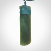This is a lovely, one-off large, green toki pendant we've made from a gorgeous New Zealand jade. It is finished in a matte sheen and is bound with our plaited cord. These are wonderful pieces that are very attractive and will last a lifetime.