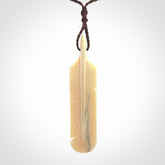 Hand carved Woolly Mammoth Tusk feather pendant. Art to Wear. Provided with adjustable cord.